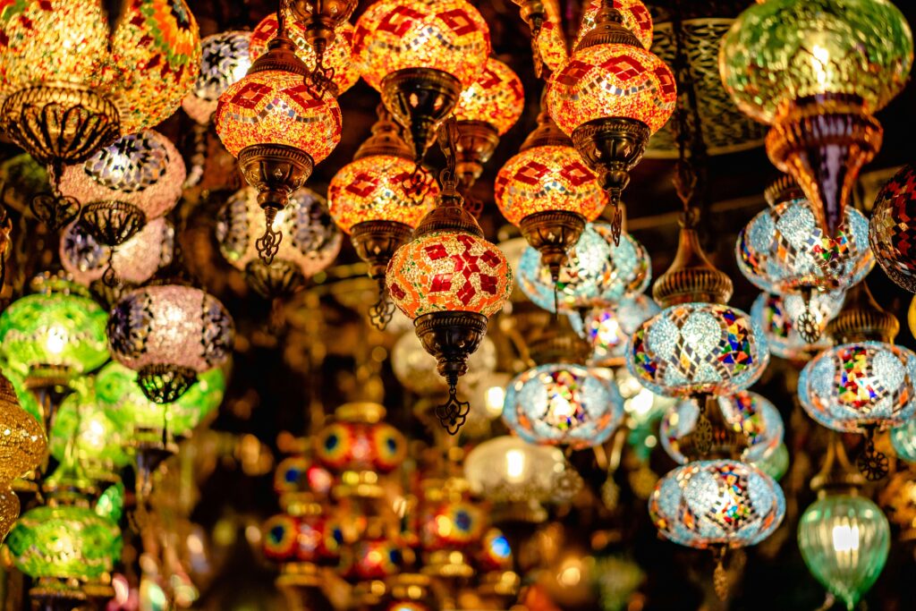 A colorful array of mosaic glass chandeliers, creating a warm and inviting atmosphere.